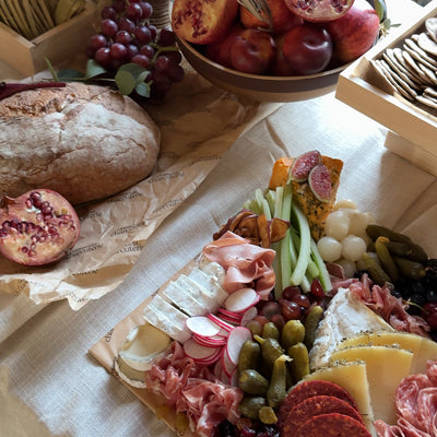 Gourmet charcuterie board with pomegranate and artisan bread styled for Cambridge event catering